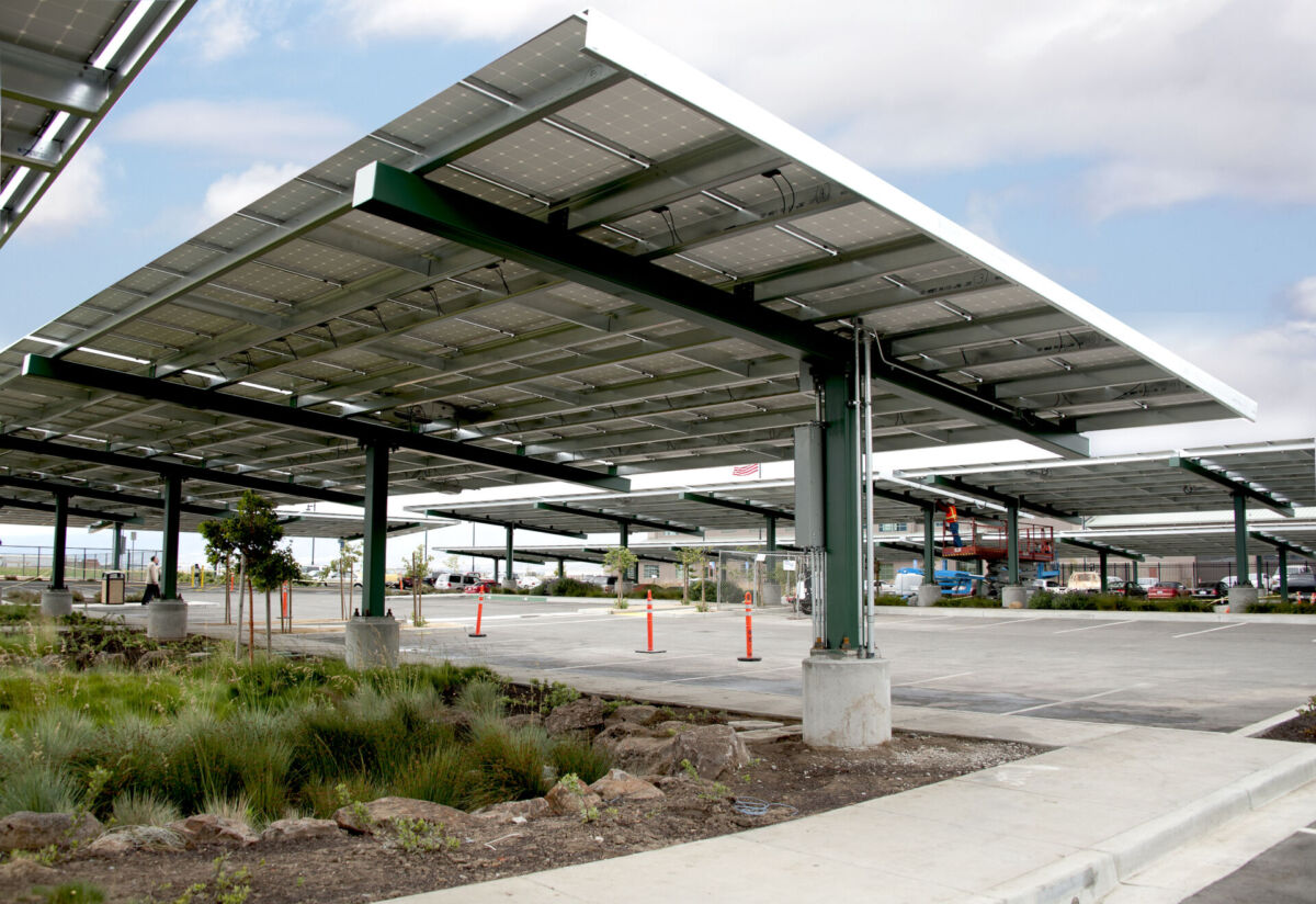 Underside view of Hartnell College’s solar parking canopy system, showcasing photovoltaic panels and structural supports installed by OPTERRA to reduce utility dependence and operating costs.