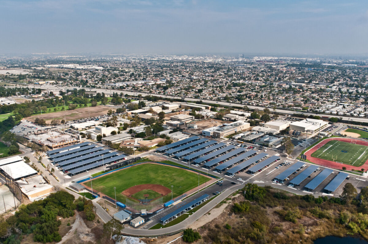 Aerial view of solar parking canopies at a Los Angeles Community College District campus, generating renewable energy while providing shaded parking and supporting district-wide energy modernization.